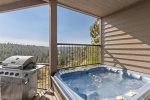 Deck with hot tub, barbeque and patio seating with panoramic views